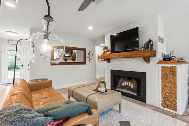 113 S Kanaio Dr, Bastrop, TX 78602 - living area with a large fireplace, a ceiling fan, baseboards, and recessed lighting