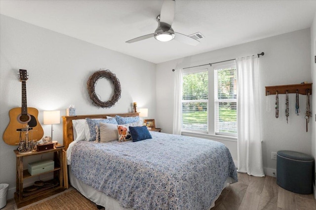 113 S Kanaio Dr, Bastrop, TX 78602 - bedroom with wood finished floors, a ceiling fan, and baseboards