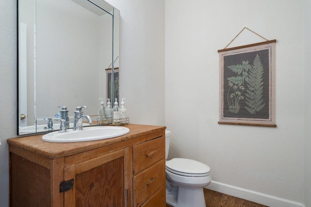 9750-9800 Ledgestone Ter, Austin, TX 78737 - bathroom with toilet, vanity, wood finished floors, and baseboards