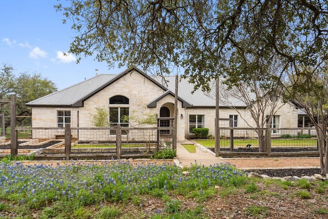 9750-9800 Ledgestone Ter, Austin, TX 78737 - view of front of home featuring stone siding, metal roof, and a gate