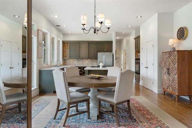 9750-9800 Ledgestone Ter, Austin, TX 78737 - dining space with light wood-style flooring, a chandelier, recessed lighting, and baseboards