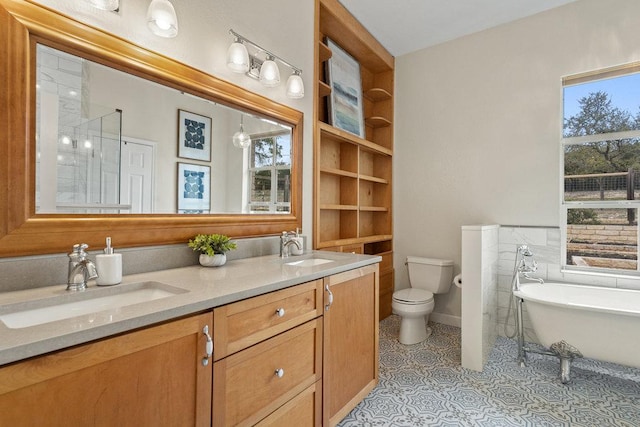 9750-9800 Ledgestone Ter, Austin, TX 78737 - bathroom with a freestanding bath, double vanity, toilet, built in features, and tile patterned floors