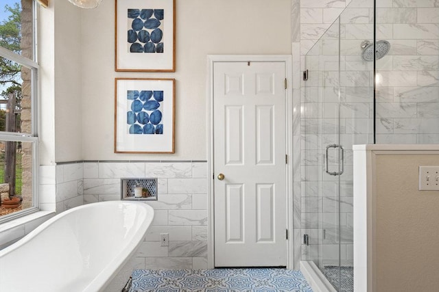 9750-9800 Ledgestone Ter, Austin, TX 78737 - full bathroom featuring a stall shower, a freestanding bath, tile patterned flooring, and tile walls