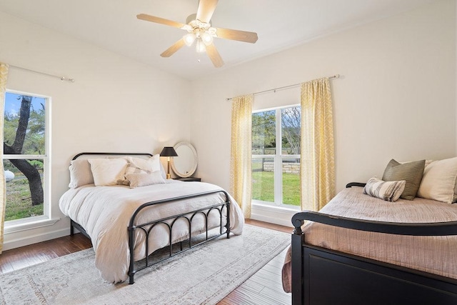 9750-9800 Ledgestone Ter, Austin, TX 78737 - bedroom with wood finished floors, ceiling fan, and baseboards