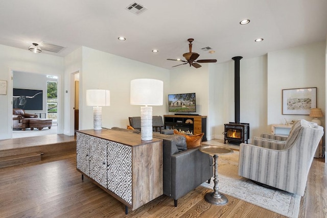 9750-9800 Ledgestone Ter, Austin, TX 78737 - living area featuring wood finished floors, a ceiling fan, recessed lighting, and a wood stove