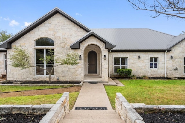 9750-9800 Ledgestone Ter, Austin, TX 78737 - french provincial home with stone siding, a front yard, and metal roof