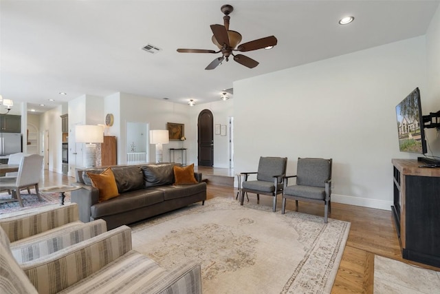 9750-9800 Ledgestone Ter, Austin, TX 78737 - living room featuring arched walkways, a ceiling fan, baseboards, light wood-type flooring, and recessed lighting