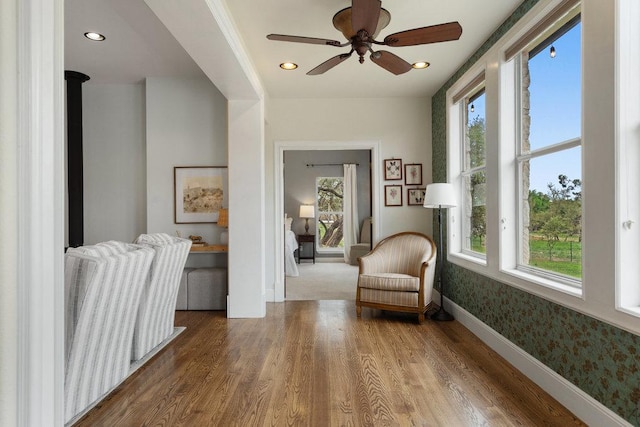9750-9800 Ledgestone Ter, Austin, TX 78737 - sitting room featuring healthy amount of natural light, wood finished floors, wallpapered walls, and recessed lighting