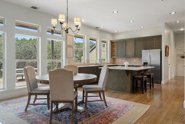 9750-9800 Ledgestone Ter, Austin, TX 78737 - dining space with healthy amount of natural light, recessed lighting, a chandelier, and light wood finished floors