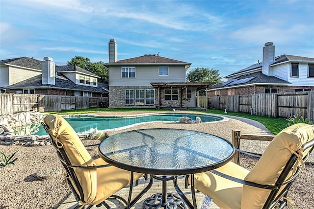 view of swimming pool featuring a fenced backyard and a patio area