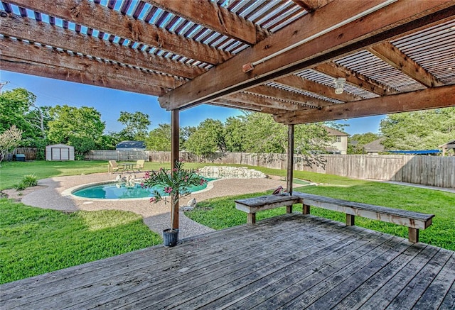 deck with a shed, a pergola, and an outbuilding