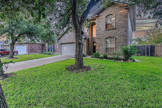 traditional-style house featuring brick siding, driveway, and an attached garage