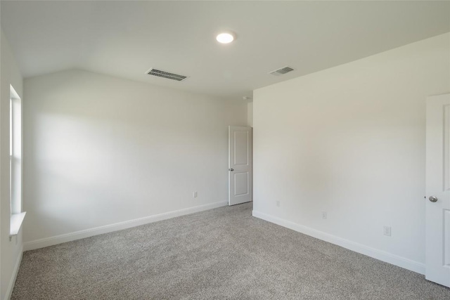 513 Tekoa Dr, Georgetown, TX 78628 - spare room featuring light colored carpet, baseboards, and vaulted ceiling