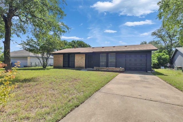4504 Little Hill Cir, Austin, TX 78725 - view of front of house with an attached garage, concrete driveway, a front lawn, and brick siding