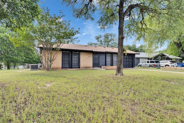 4504 Little Hill Cir, Austin, TX 78725 - view of front of property featuring a garage, a front yard, and brick siding