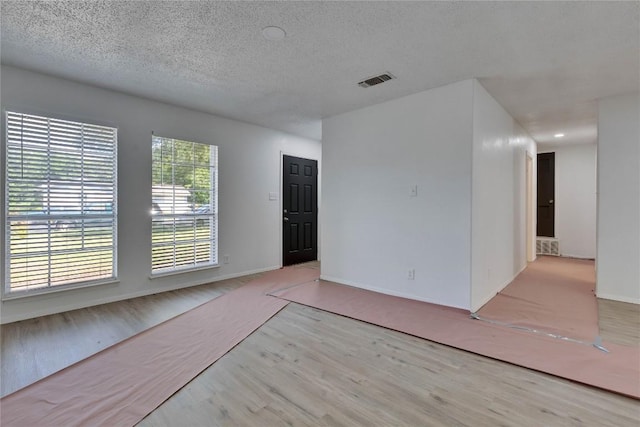 4504 Little Hill Cir, Austin, TX 78725 - unfurnished room featuring wood finished floors, a textured ceiling, and baseboards