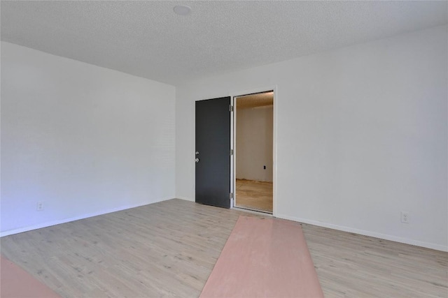 4504 Little Hill Cir, Austin, TX 78725 - empty room with light wood finished floors and a textured ceiling