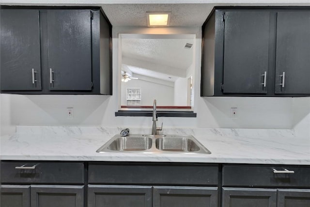4504 Little Hill Cir, Austin, TX 78725 - kitchen featuring a sink, a textured ceiling, and a ceiling fan