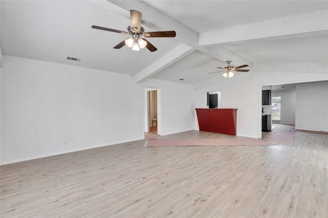 4504 Little Hill Cir, Austin, TX 78725 - unfurnished living room featuring ceiling fan, light wood-style flooring, baseboards, and a textured ceiling