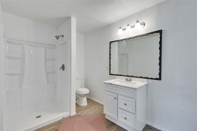 4504 Little Hill Cir, Austin, TX 78725 - full bath with wood finished floors, toilet, a shower, vanity, and baseboards