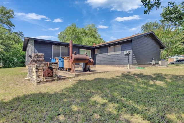 4504 Little Hill Cir, Austin, TX 78725 - rear view of property with central AC unit, a lawn, and a patio