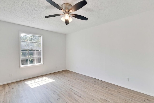 4504 Little Hill Cir, Austin, TX 78725 - empty room featuring wood finished floors, a textured ceiling, a ceiling fan, and baseboards