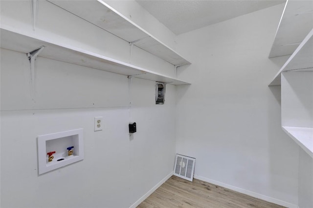 4504 Little Hill Cir, Austin, TX 78725 - clothes washing area with washer hookup, wood finished floors, and baseboards