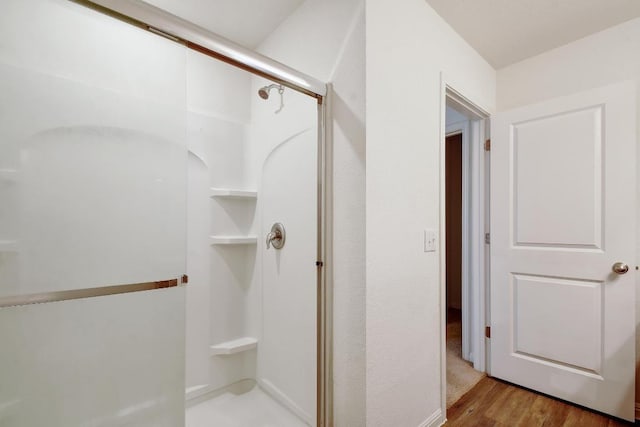 750 Bunton Reserve Blvd, Kyle, TX 78640 - bathroom featuring a shower stall and wood finished floors