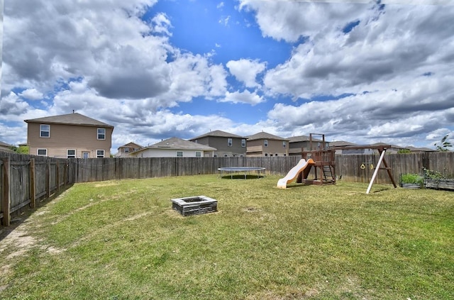 750 Bunton Reserve Blvd, Kyle, TX 78640 - fenced backyard with a trampoline, a playground, and a residential view
