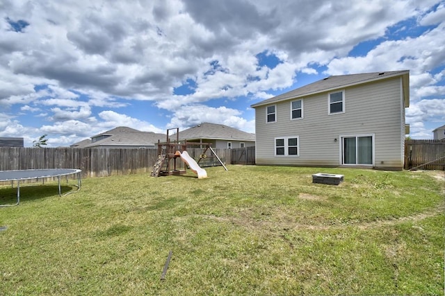 750 Bunton Reserve Blvd, Kyle, TX 78640 - back of house with a playground, a trampoline, and a fenced backyard
