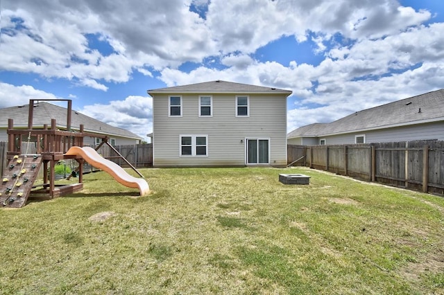 750 Bunton Reserve Blvd, Kyle, TX 78640 - back of house with an outdoor fire pit, a playground, and a fenced backyard