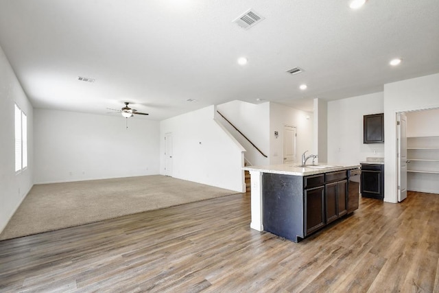 750 Bunton Reserve Blvd, Kyle, TX 78640 - kitchen featuring ceiling fan, open floor plan, light countertops, light wood-type flooring, and recessed lighting