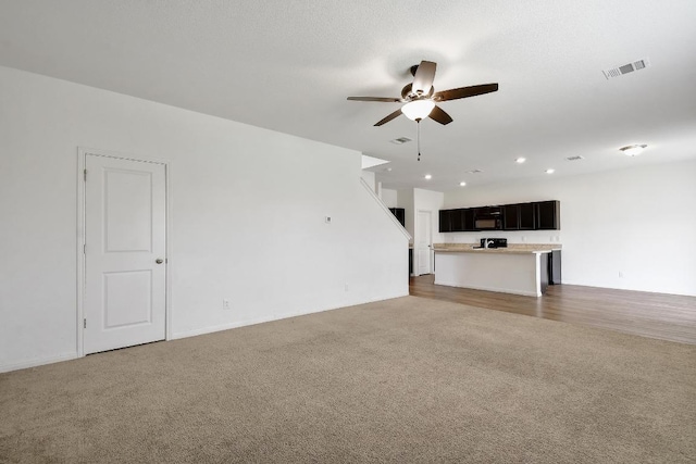 750 Bunton Reserve Blvd, Kyle, TX 78640 - unfurnished living room featuring carpet, ceiling fan, and recessed lighting