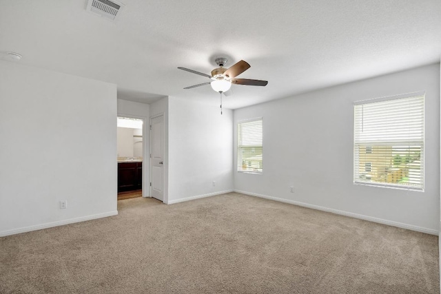 750 Bunton Reserve Blvd, Kyle, TX 78640 - spare room featuring light colored carpet, ceiling fan, and a smoke detector