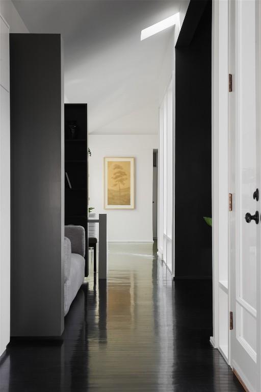 hall with wood finished floors and baseboards