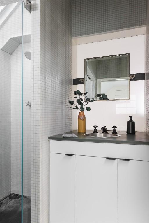 bar area with a sink and tile walls
