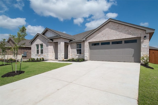 537 Tekoa Dr, Georgetown, TX 78628 - view of front of house featuring driveway, a garage, a front lawn, board and batten siding, and stone siding