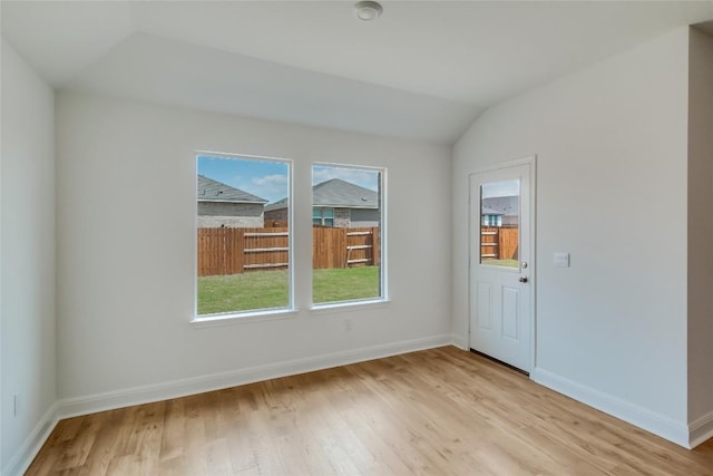 537 Tekoa Dr, Georgetown, TX 78628 - unfurnished room with vaulted ceiling, light wood-style flooring, and baseboards
