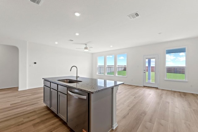 3759 Liberi Ln, Round Rock, TX 78665 - kitchen with a sink, dishwasher, stone counters, open floor plan, and a kitchen island with sink