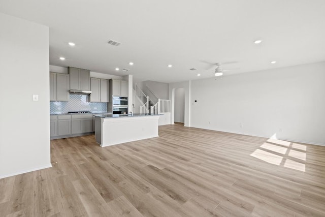 3759 Liberi Ln, Round Rock, TX 78665 - unfurnished living room with a ceiling fan, recessed lighting, light wood-style flooring, baseboards, and a sink