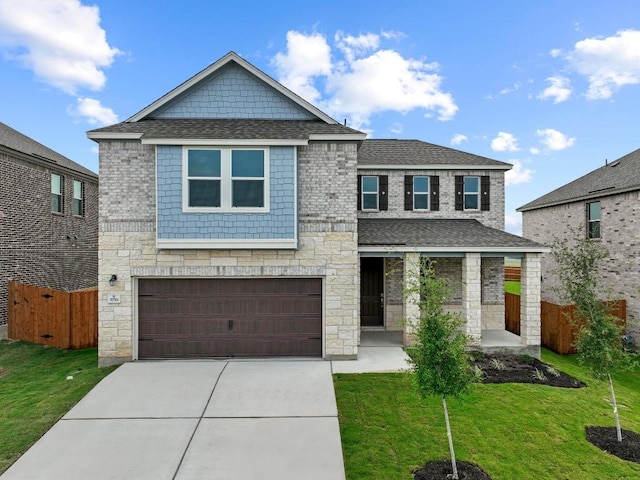 3759 Liberi Ln, Round Rock, TX 78665 - view of front of home with stone siding, driveway, an attached garage, and a shingled roof