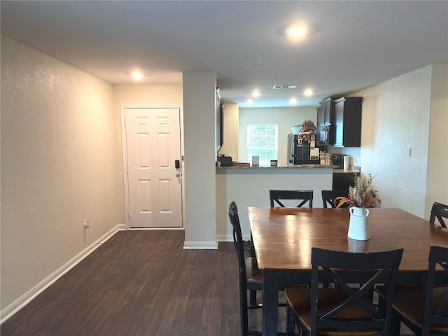 721 Yearwood Ln Unit 45E, Jarrell, TX 76537 - dining area featuring dark wood-style floors, baseboards, and a textured wall