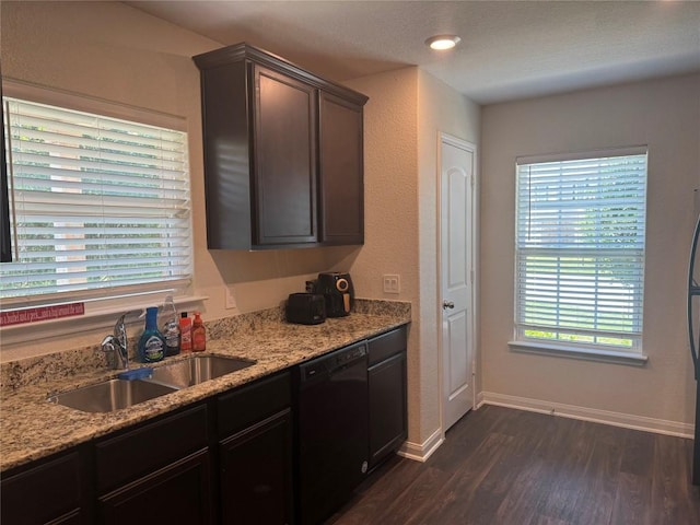 721 Yearwood Ln Unit 45E, Jarrell, TX 76537 - kitchen with dishwasher, a sink, dark wood-style floors, baseboards, and light stone countertops