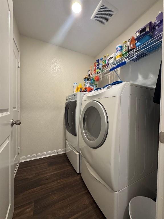 721 Yearwood Ln Unit 45E, Jarrell, TX 76537 - clothes washing area with dark wood finished floors, washer and dryer, and baseboards