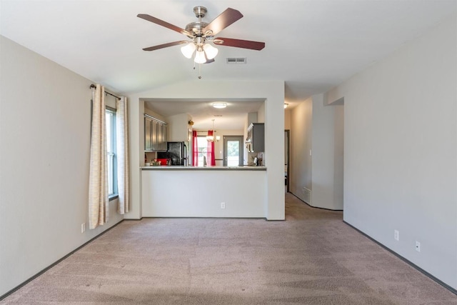 404 Paige Bnd, Hutto, TX 78634 - unfurnished living room with carpet flooring, a ceiling fan, and vaulted ceiling
