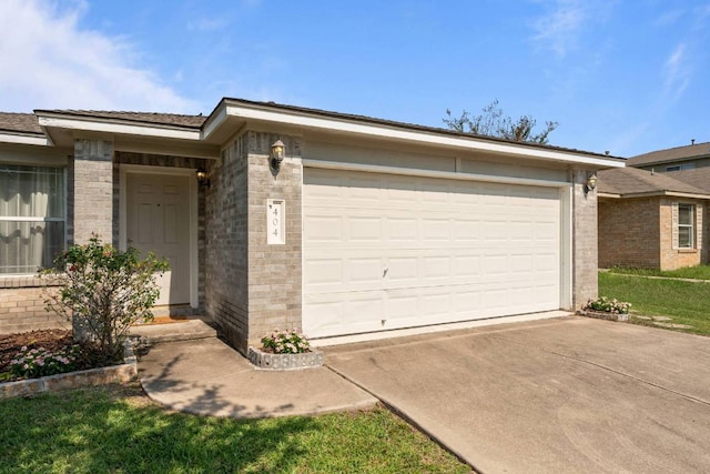 404 Paige Bnd, Hutto, TX 78634 - view of front of house featuring brick siding, concrete driveway, and an attached garage