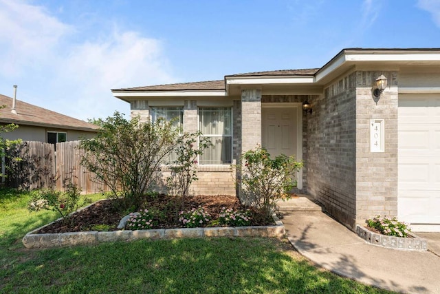 404 Paige Bnd, Hutto, TX 78634 - doorway to property featuring an attached garage and brick siding