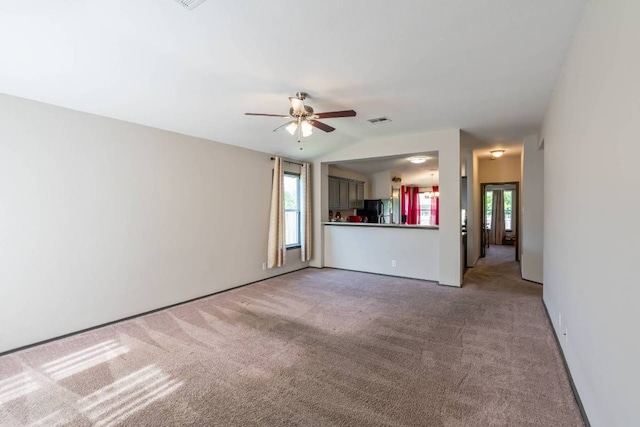 404 Paige Bnd, Hutto, TX 78634 - unfurnished living room featuring plenty of natural light, carpet, and a ceiling fan