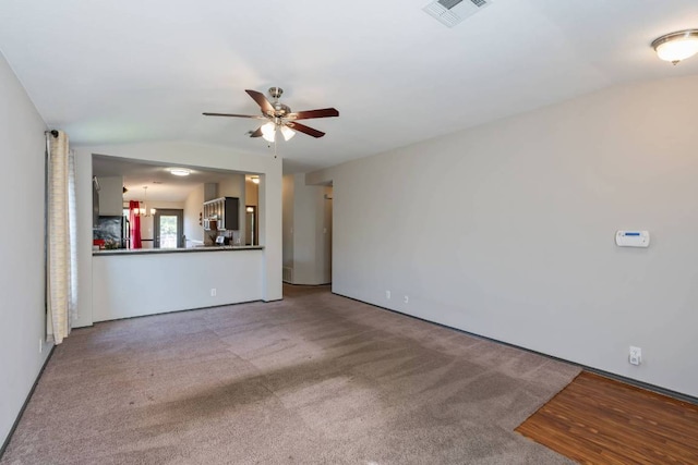 404 Paige Bnd, Hutto, TX 78634 - unfurnished living room featuring lofted ceiling, a ceiling fan, and carpet floors