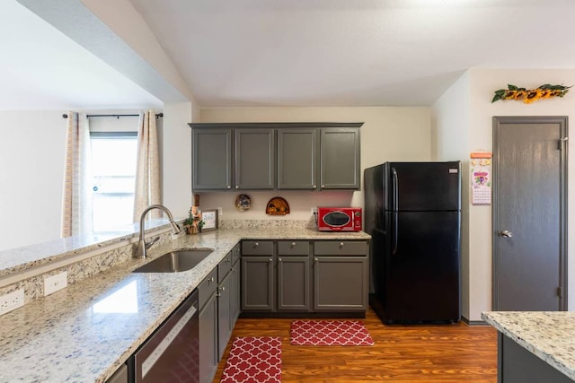 404 Paige Bnd, Hutto, TX 78634 - kitchen featuring freestanding refrigerator, stainless steel dishwasher, dark wood-style flooring, light stone counters, and gray cabinets